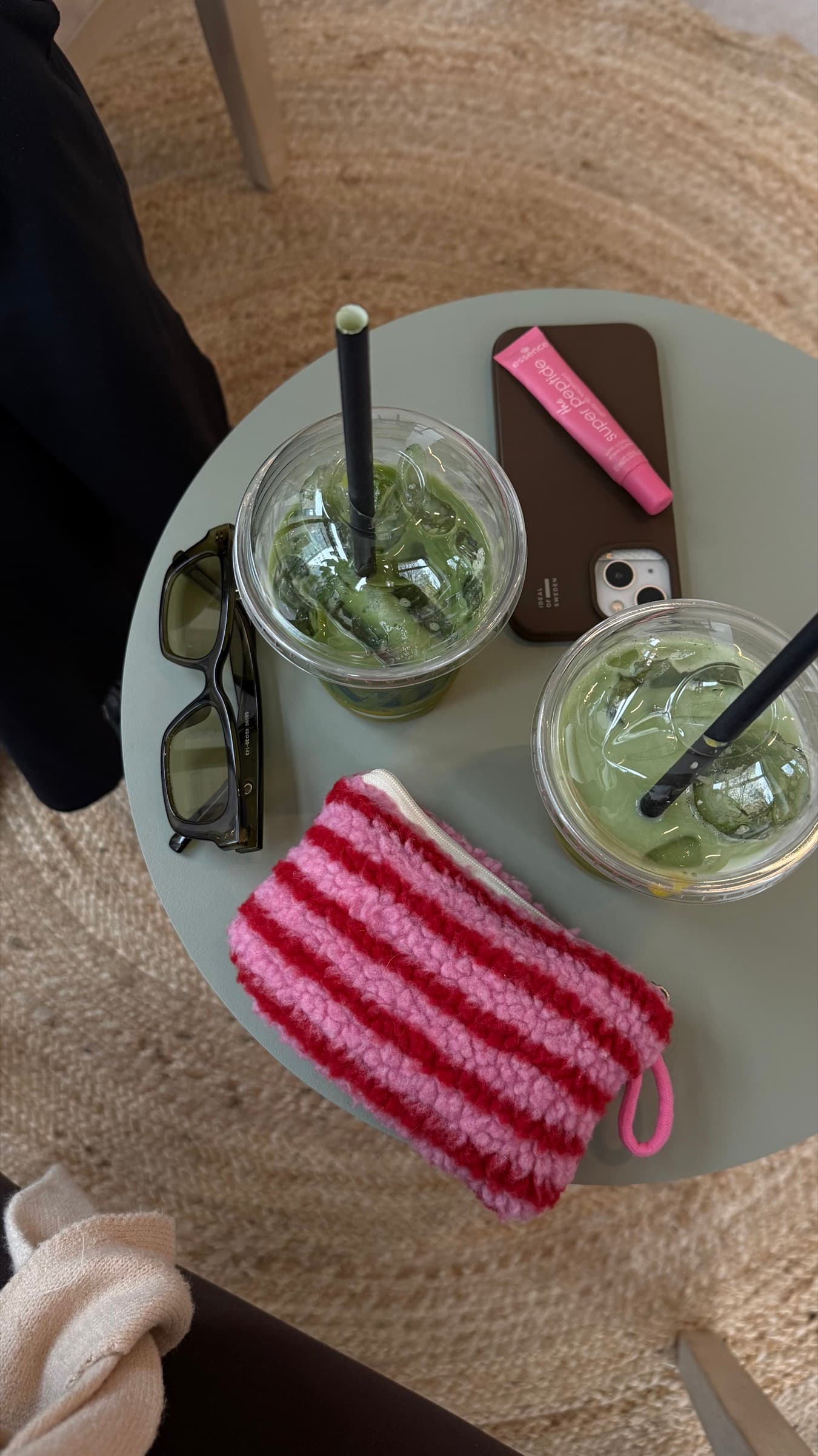 Two iced matcha drinks on a café table